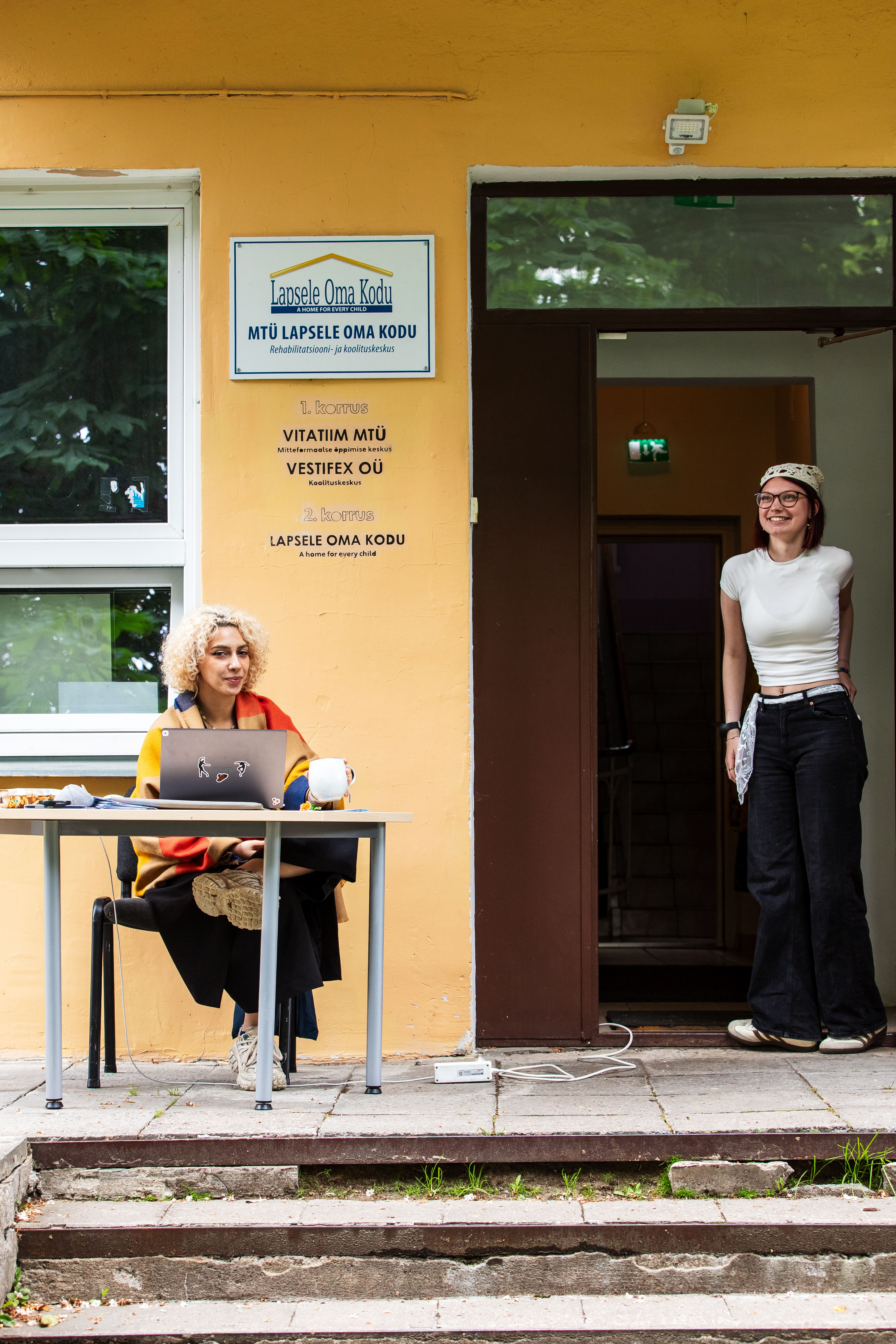 Young people welcoming visitors at a community centre