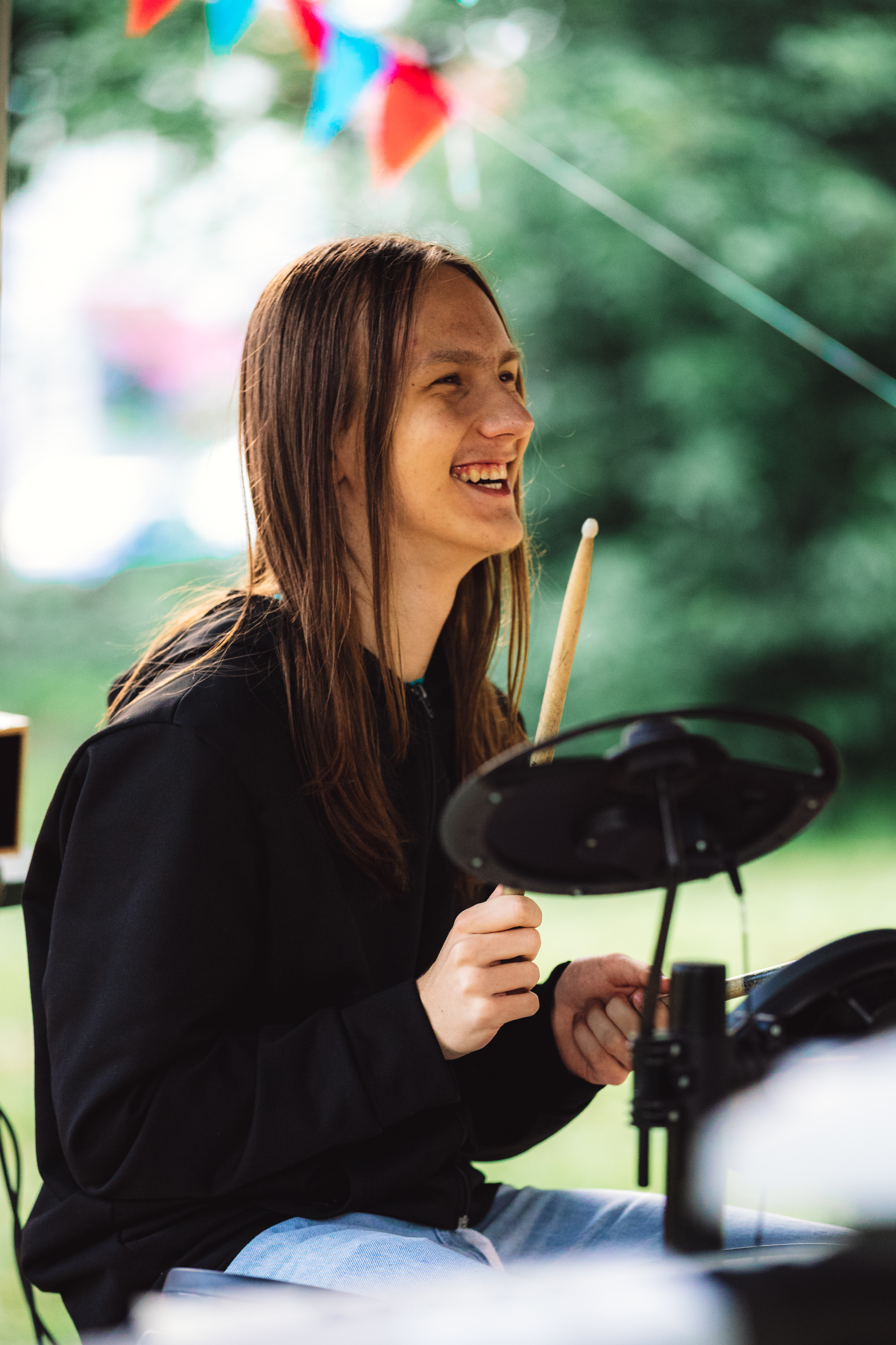 Young musician playing electronic drums outdoors