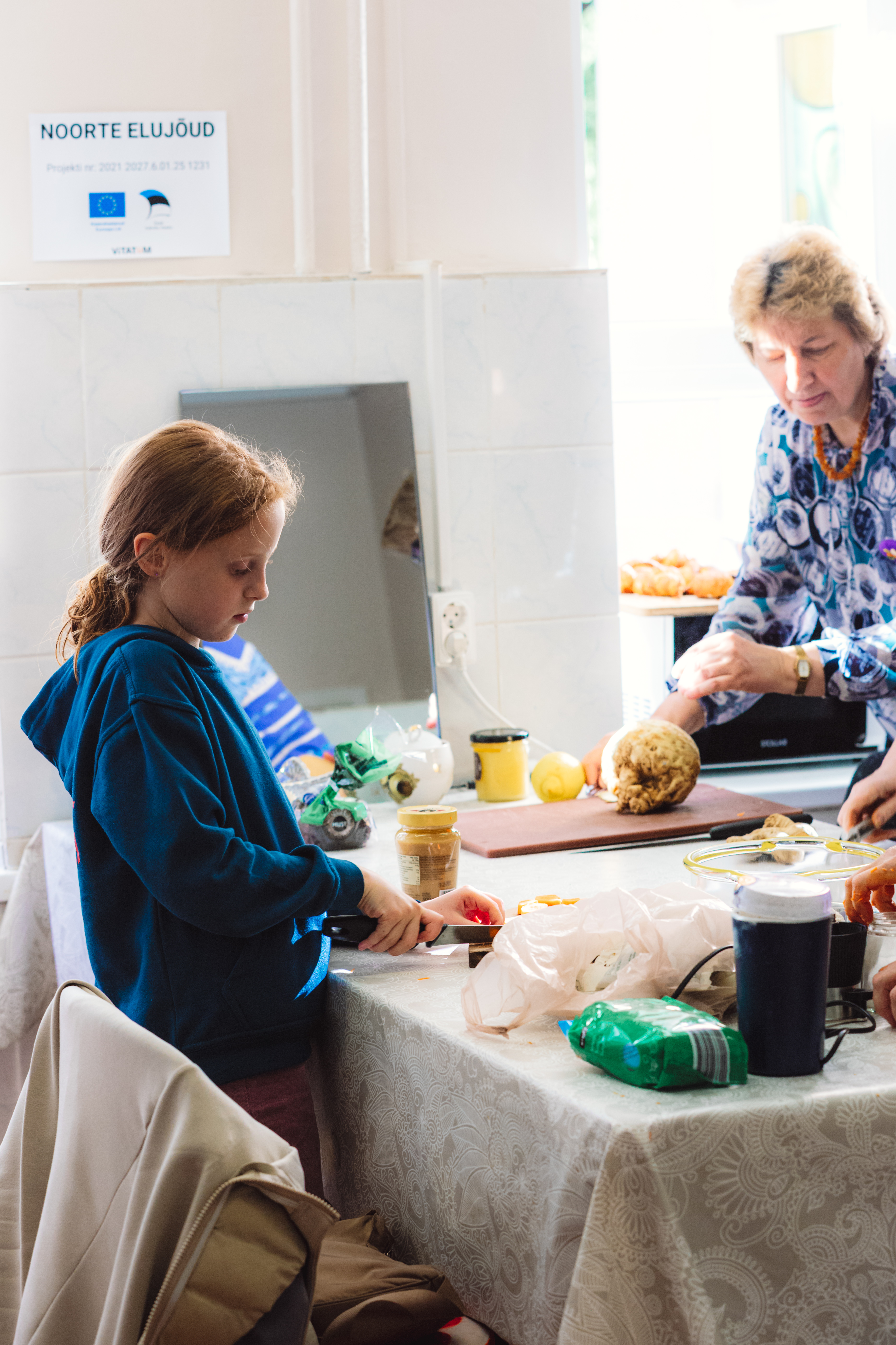 Young person participating in a community cooking activity